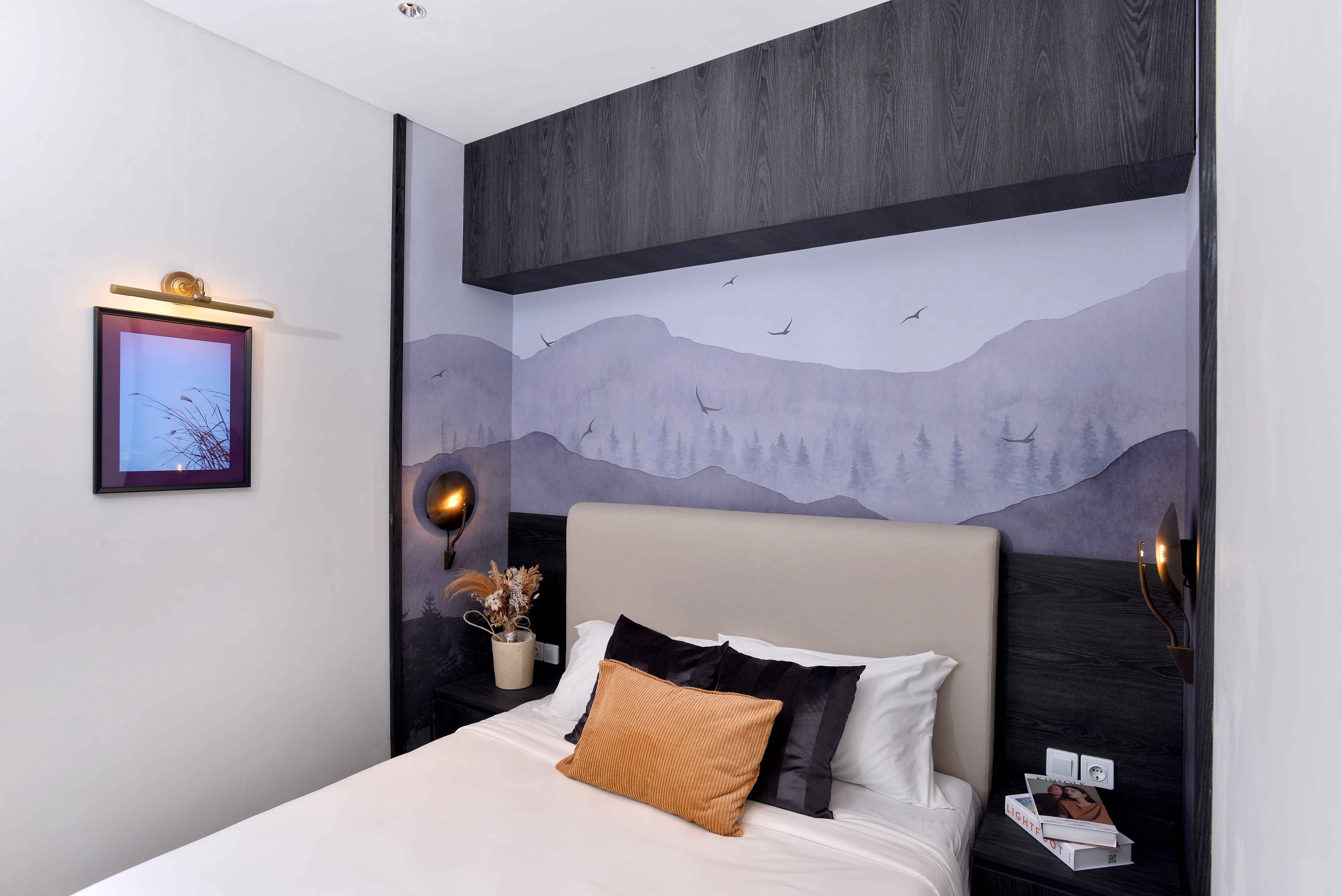 Interior view of a modern bedroom with a bed and decorative items